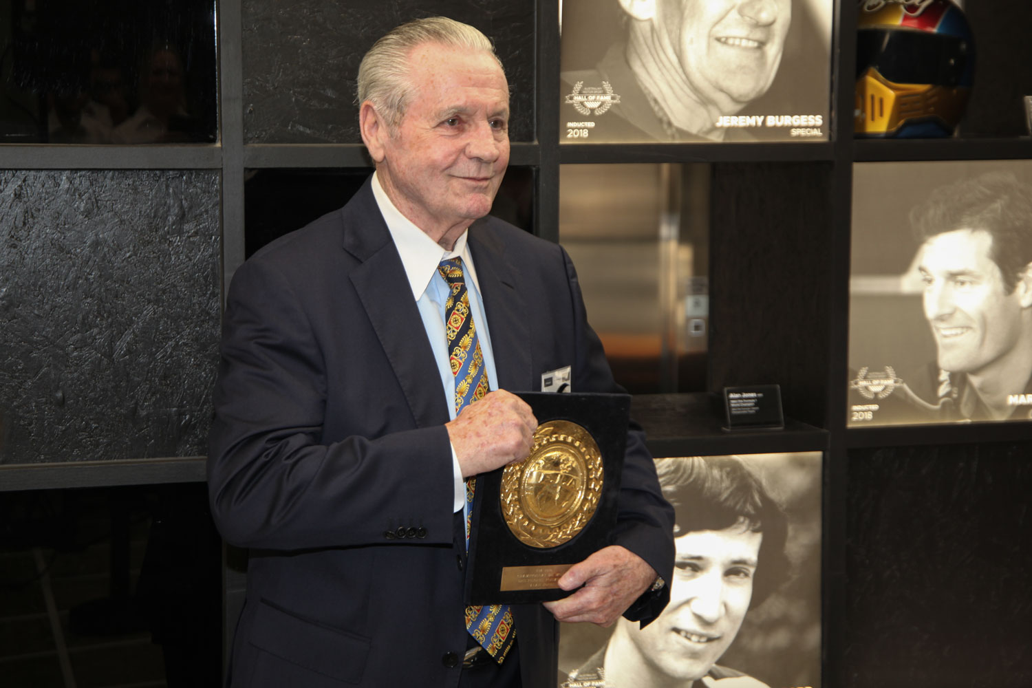 Alan Jones presenting his Formula 1 World Championship trophy